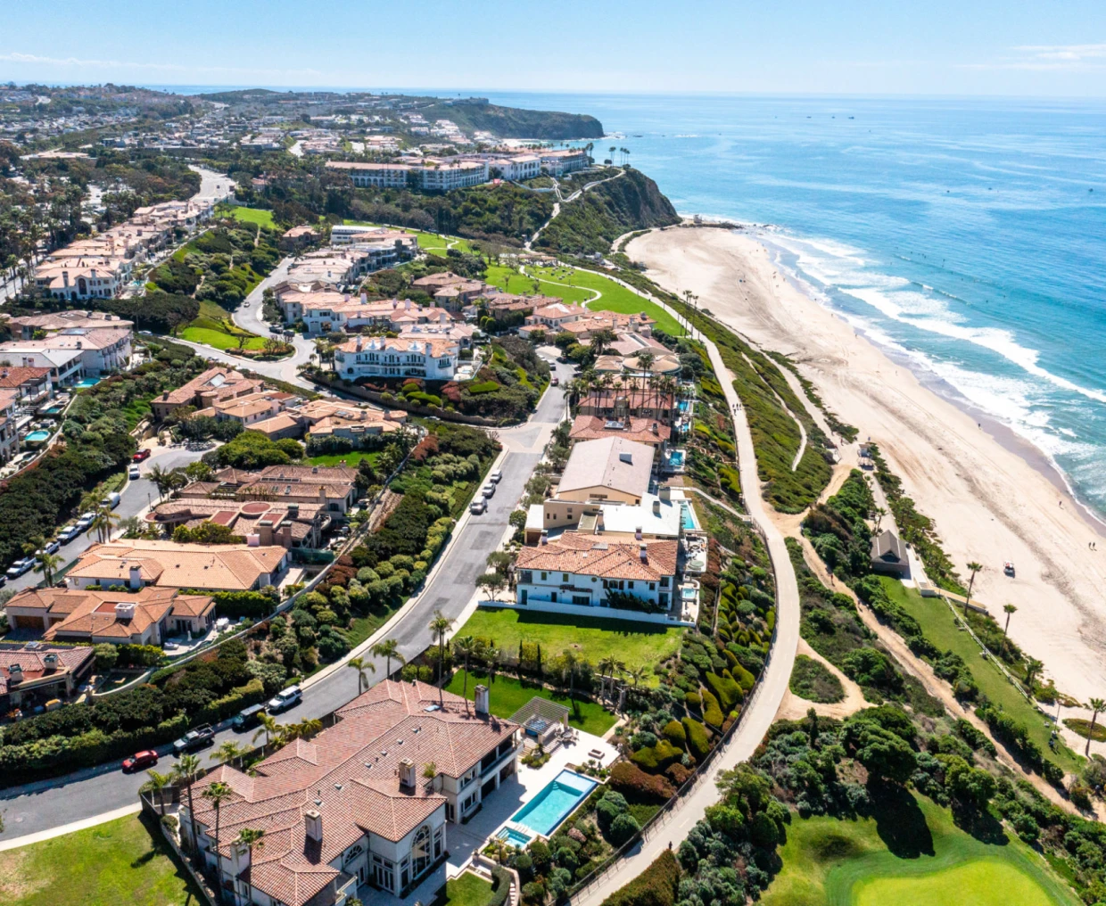 Coastal town with beach and houses aerial view.